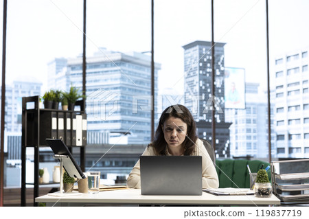 Female director reviewing sales reports and market trends from analytics, using data driven insights to obtain funding and maximize business development opportunities. Strategic thinking. Female director reviewing sales reports and market trends from analytics, using data driven insights to obtain funding and maximize business development opportunities. Strategic thinking. 119837719