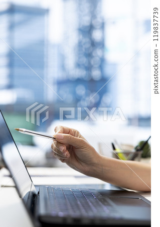 HR department worker using laptop to do background checks for potential job applicants. Close up of employer using notebook to implement recruiting strategies to attract qualified candidates 119837739