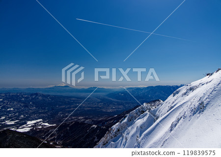 Mt. Fuji and contrails seen from the summit of Mt. Akadake in the Yatsugatake mountain range in midwinter 119839575
