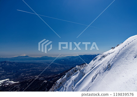 Mt. Fuji and contrails seen from the summit of Mt. Akadake in the Yatsugatake mountain range in midwinter 119839576