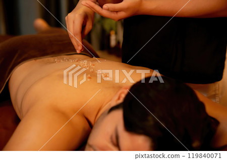 Man customer having exfoliation treatment in luxury spa. Quiescent 119840071