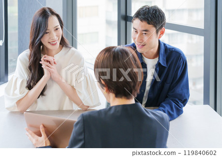 A female real estate salesperson and her customer couple 119840602