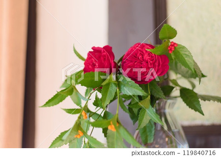 Crimson roses blooming on a crystal base Crimson roses blooming on a crystal base 119840716