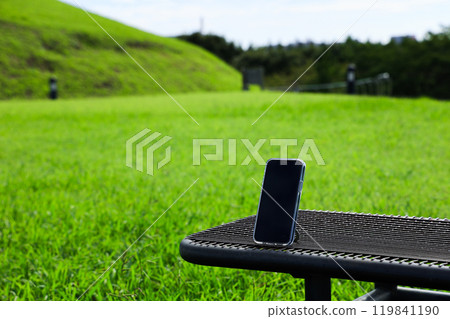 Smartphone on a park bench Smartphone on a park bench 119841190