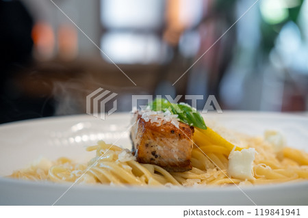 Salmon Fettuccine with cheese served on plate 119841941