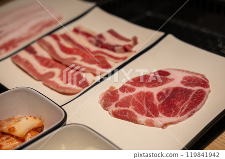 Korean Style sliced meat on plate. BBQ rare meat with soft focus 119841942