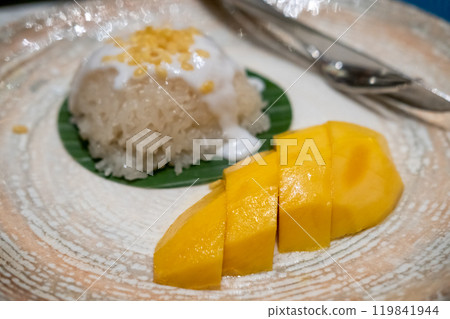 Mango sticky rice served on plate. It is a famous Thai dessert dish Mango sticky rice served on plate. It is a famous Thai dessert dish 119841944