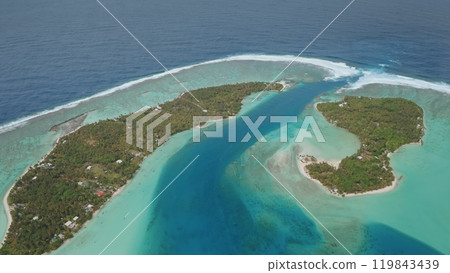 Aerial view of Maupiti island, coral reef motu entrance to lagoon bay, French Polynesia. Turquoise water, lush greenery, remote tropical beauty. Wild nature paradise. Exotic tourist travel destination 119843439