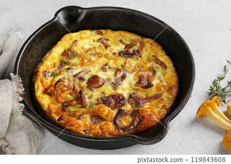 Healthy breakfast, omelette with fried seasonal forest mushrooms Chanterelles in frying pan on a light background Healthy breakfast, omelette with fried seasonal forest mushrooms Chanterelles in frying pan on a light background 119843608