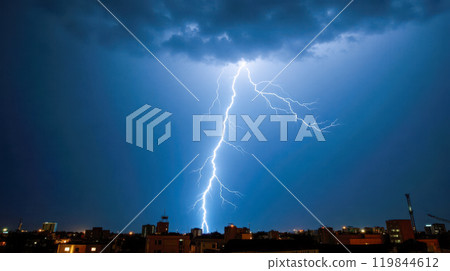 nighttime thunderstorm over cityscape, bright lightning bolt illuminating dark sky above skyscrapers, electric weather event in urban setting, powerful storm showcasing dramatic contrast nighttime thunderstorm over cityscape, bright lightning bolt illuminating dark sky above skyscrapers, electric weather event in urban setting, powerful storm showcasing dramatic contrast 119844612
