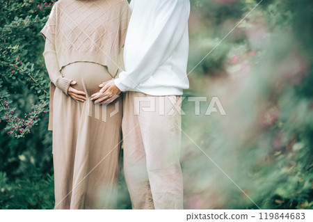 一名男子將手放在森林裡摀著肚子的孕婦身上（孕婦照） 119844683