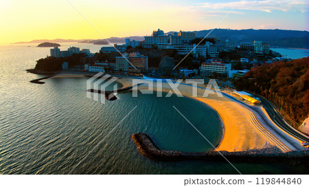 A famous view of Gamagori City, Aichi Prefecture, Palm Beach in Nishiura Onsen Town illuminated by the setting sun, photographed by drone from above the sea side 119844840