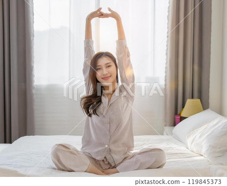 A young woman waking up comfortably 119845373