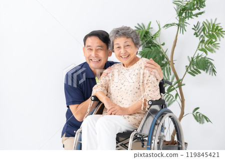Senior woman in wheelchair and male caregiver 119845421