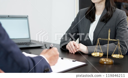 A woman consulting a lawyer about a problem 119846211
