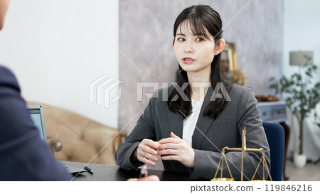 A woman consulting a lawyer about a problem 119846216