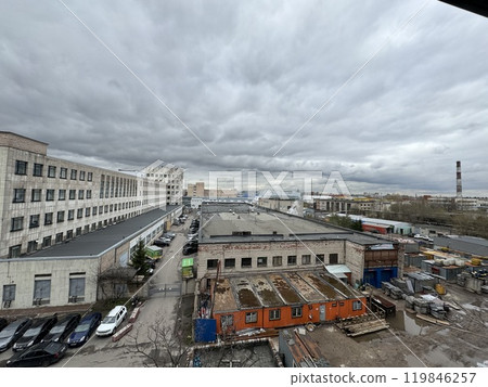 A striking Industrial Urban Landscape is captured under the dramatic presence of Cloudy Skies 119846257