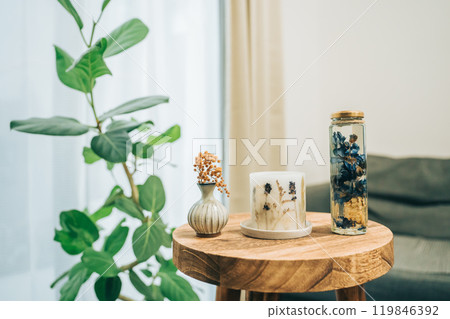 Aromatherapy container, blue herbarium and dried mimosa flower vase on a table Aromatherapy container, blue herbarium and dried mimosa flower vase on a table 119846392