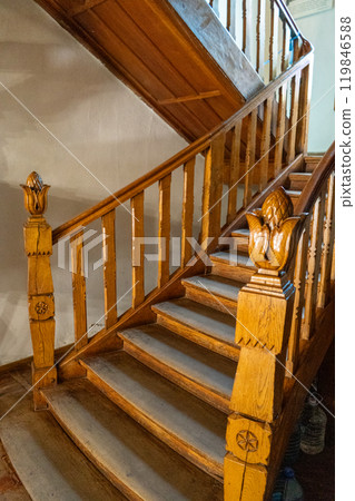 Wooden railings on the stairs. Wood carving. Artichoke in the interior and architecture. Wooden railings on the stairs. Wood carving. Artichoke in the interior and architecture. 119846588