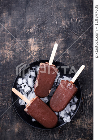 Chocolate ice cream popsicles in glaze Chocolate ice cream popsicles in glaze 119847638