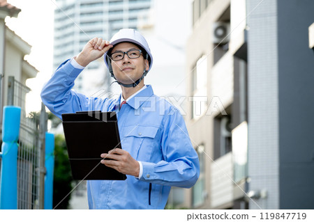 A man working at a construction site A man working at a construction site 119847719