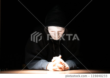 A man wearing a mask and looking at a computer A man wearing a mask and looking at a computer 119848233
