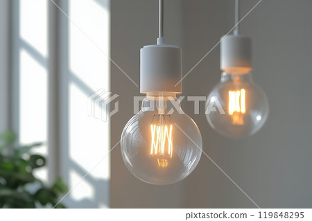 Minimalist light bulbs with visible filaments, casting a warm glow in a sunlit modern interior 119848295