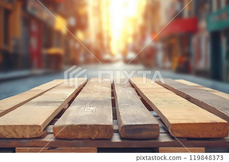 Wooden planks aligned on an urban street, bathed in golden sunlight, adding warmth to the scene 119848373
