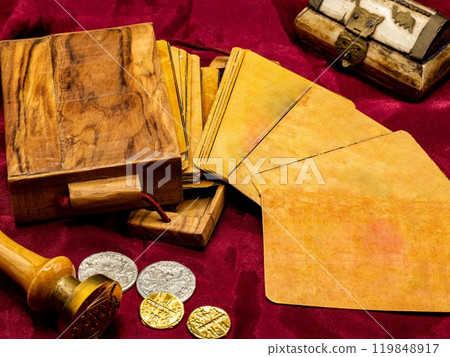 deck of medieval italian board playing cards with blank and white card, on the table along with coins and wooden card holder deck of medieval italian board playing cards with blank and white card, on the table along with coins and wooden card holder 119848917