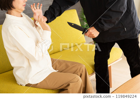 Robber with knife and frightened senior woman 119849224