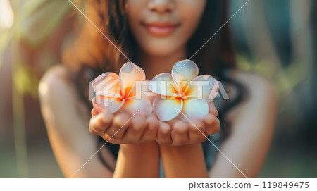 Woman holding plumeria flower 03 119849475