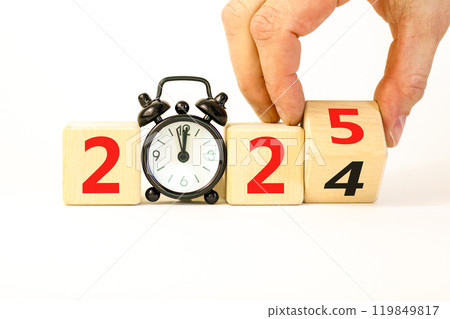 Business concept of 2025 new year symbol. Beautiful turned wooden cube and changed number 2024 to 2025. Beautiful white table background, copy space. Alarm clock. Business 2025 happy new year concept. 119849817
