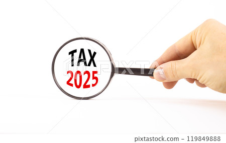 Planning tax 2025 new year symbol. Concept words Tax 2025 on beautiful white paper in magnifying glass. Businessman hand. Beautiful white background. Business tax 2025 new year concept. Copy space. Planning tax 2025 new year symbol. Concept words Tax 2025 on beautiful white paper in magnifying glass. Businessman hand. Beautiful white background. Business tax 2025 new year concept. Copy space. 119849888