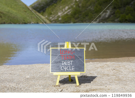 Long-term debt cycle symbol. Concept words Long-term debt cycle on beautiful black chalk blackboard. Beautiful mountain lake background. Business Long-term debt cycle concept. Copy space. Long-term debt cycle symbol. Concept words Long-term debt cycle on beautiful black chalk blackboard. Beautiful mountain lake background. Business Long-term debt cycle concept. Copy space. 119849936