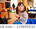 A girl eating chocolate while taking a break 119850532