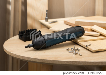 The image showcases a mini handheld cordless screwdriver, ideal for quick DIY tasks. 119850553