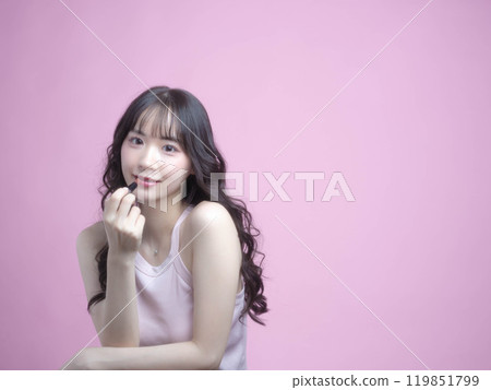 A woman applying makeup with cosmetics 119851799