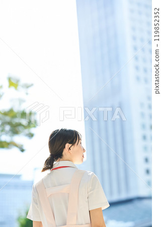 A young woman wearing a white coat and apron 119852352