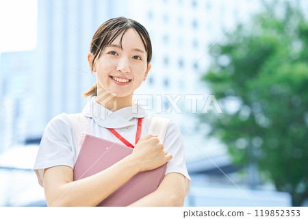 A young woman wearing a white coat and apron 119852353