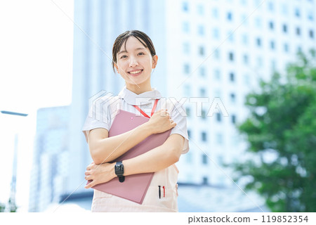 A young woman wearing a white coat and apron 119852354