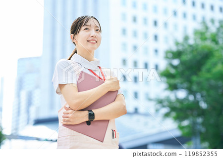 A young woman wearing a white coat and apron 119852355