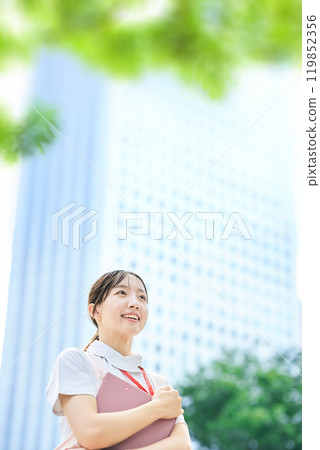 A young woman wearing a white coat and apron 119852356