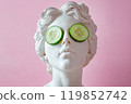Statue of a Greek goddess with cucumber slices on eyes. Sculpture on spa treatments after bath. Beauty procedures, self-care, art, wellness, cosmetics and beauty salon, relaxation concept 119852742