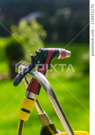 On a sunny day, the water hose is held onto the water pipe. High quality photo On a sunny day, the water hose is held onto the water pipe. High quality photo 119853270