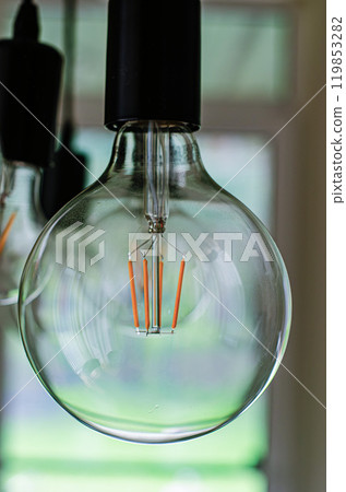 Big glass bulb in the room in front of window. High quality photo 119853282