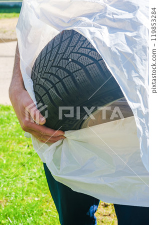 A close up of the mans hands changing tires on the car. High quality photo 119853284