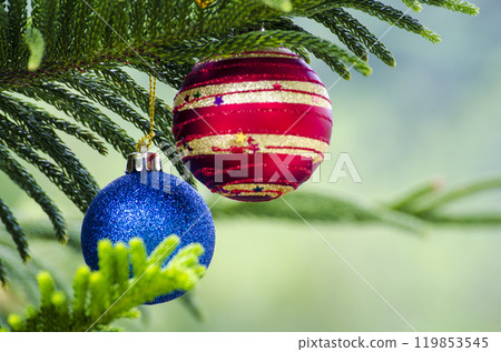 Seasons Greetings with Christmas ball on Pine Tree. Christmas celebration concept Seasons Greetings with Christmas ball on Pine Tree. Christmas celebration concept 119853545