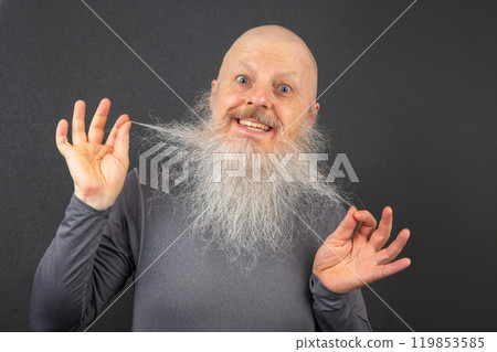 happy bald man extending his arms to demonstrate the fullness and length of his white beard 119853585