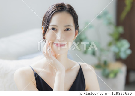 A woman doing skin care in the living room A woman doing skin care in the living room 119853650