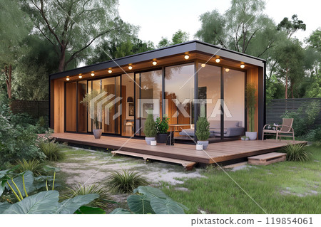 Small modern timber house with an open floor plan interior and large windows. Small and cozy house with wooden terrace surrounded with green lawn and garden 119854061